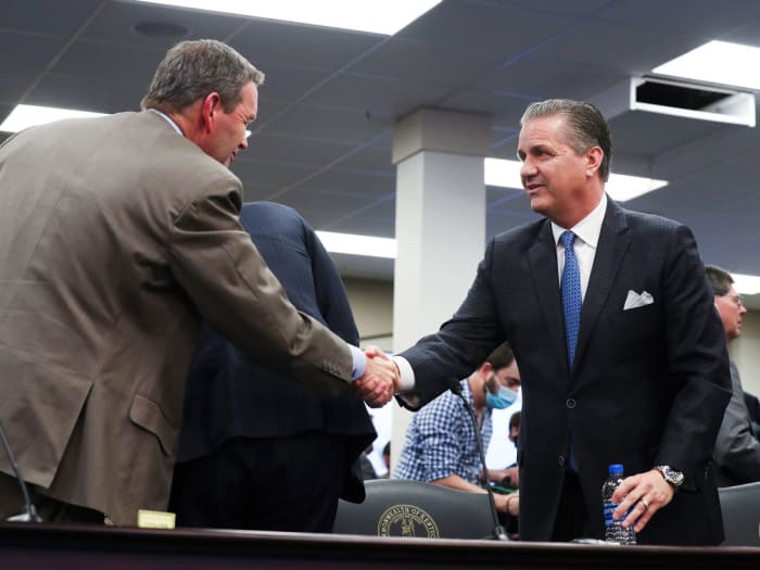 Kentucky AD Mitch Barnhart, left, and John Calipari shake hands